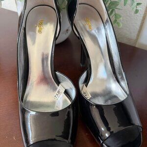 This is a pair of black patent leather peep-toe high heels.